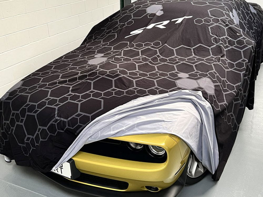 Car Reveal Cover over Dodge Challenger showing headlamp