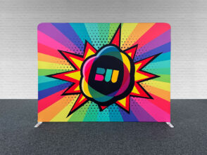Vibrant fabric wall display with bold graphic design featuring a central logo and colorful rays, ideal for exhibition stands and engaging displays.