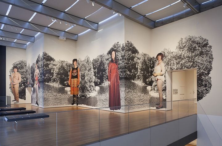 Large format wall graphics featuring life-size figures in a gallery setting, showcasing customizable printed designs suitable for museums and exhibitions.